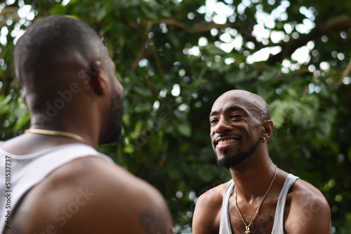 USA, Louisiana, Smiling gay couple talking in forest © Cultura Creative