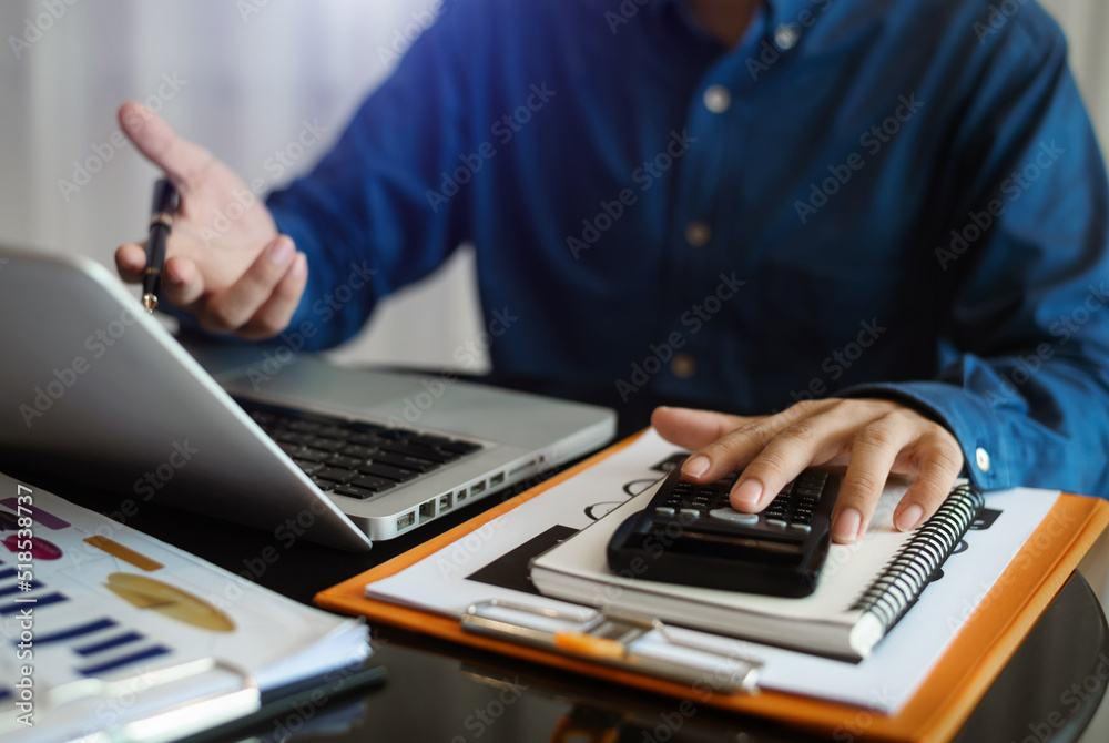 Business man are calculating income-expenditure and analyzing real estate investment data at office, Accounting Financial and tax systems concept. Business man are calculating income-expenditure and analyzing real estate investment data at office, Accounting Financial and tax systems concept.