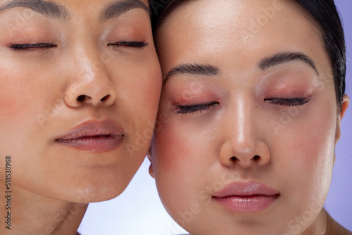 Close-up�of two women cheek to cheek with eyes closed