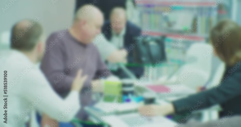 Unrecognizable people who are holding a business meeting or negotiation. Blurry defocused video. Business theme background. Unrecognizable people who are holding a business meeting or negotiation. Blurry defocused video. Business theme background.