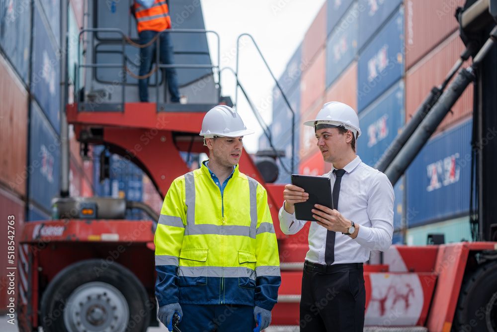 Businessman and Technician team working planning the transportation for import or export at overseas shipping container yard. Businessman and Technician team working planning the transportation for import or export at overseas shipping container yard.