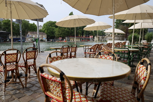 Fotobehang parisian cafe terrace on canal embankment