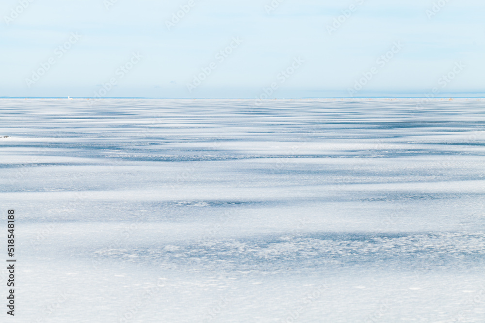 Frozen Baltic Sea under blue sky on a sunny day