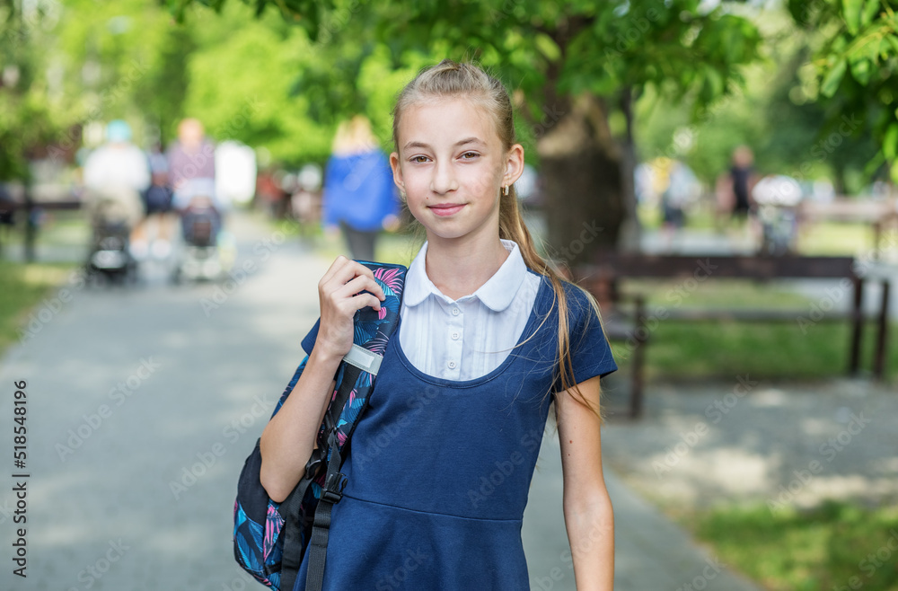 Beautiful preteen girl with backpack goes to school. Concept of back to school and education