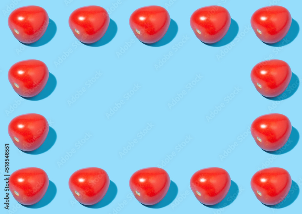 Creative frame of ripe red tomatoes on blue background Creative frame of ripe red tomatoes on blue background