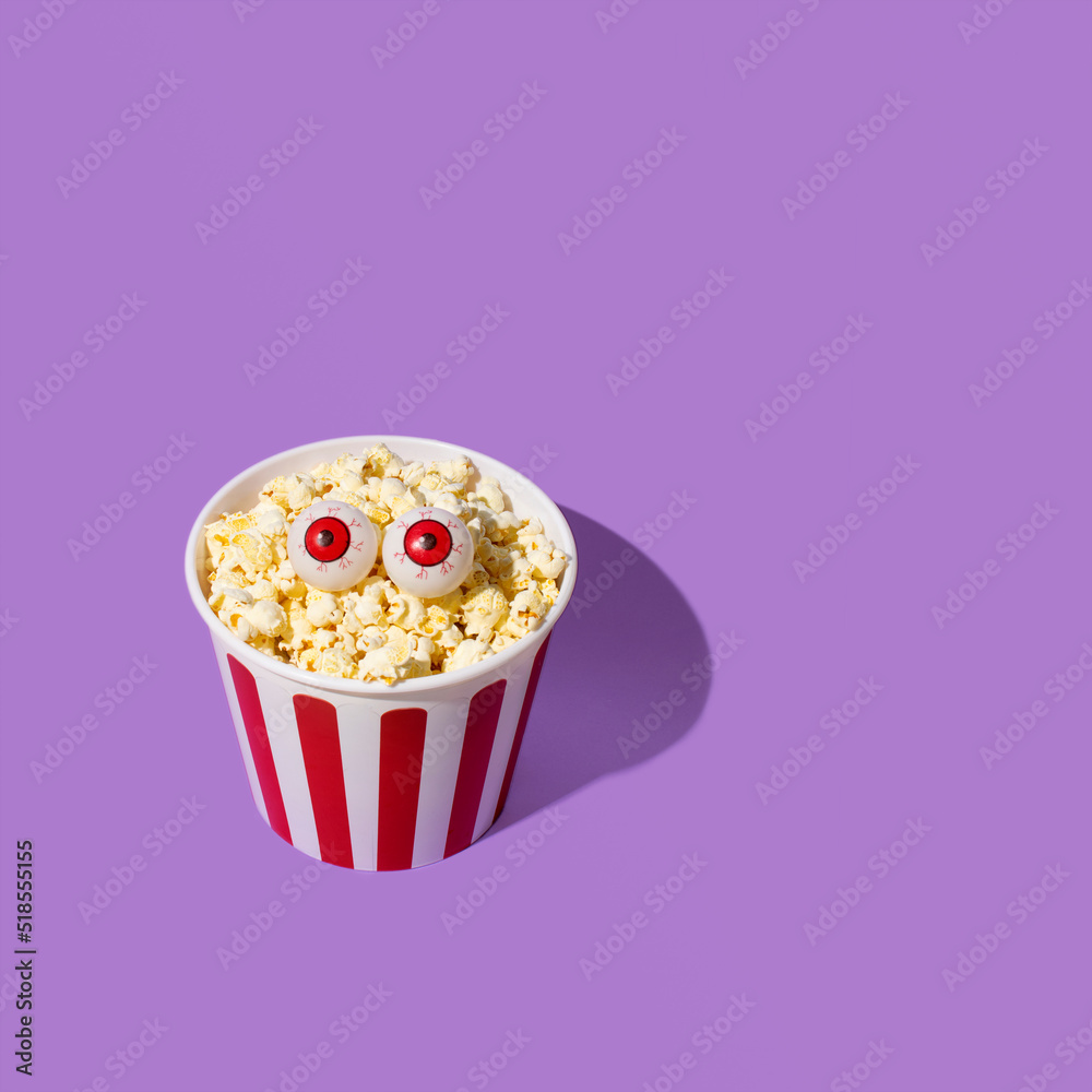 Popcorn bucket and funny eye balls, minimal horror creative concept. Halloween inspiration.
