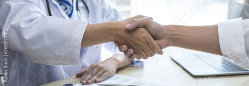Doctor shake hands to congratulate the patient who came to treat the sick and recovered normally. Congratulations between doctor and patient  Medical treatment and health check.