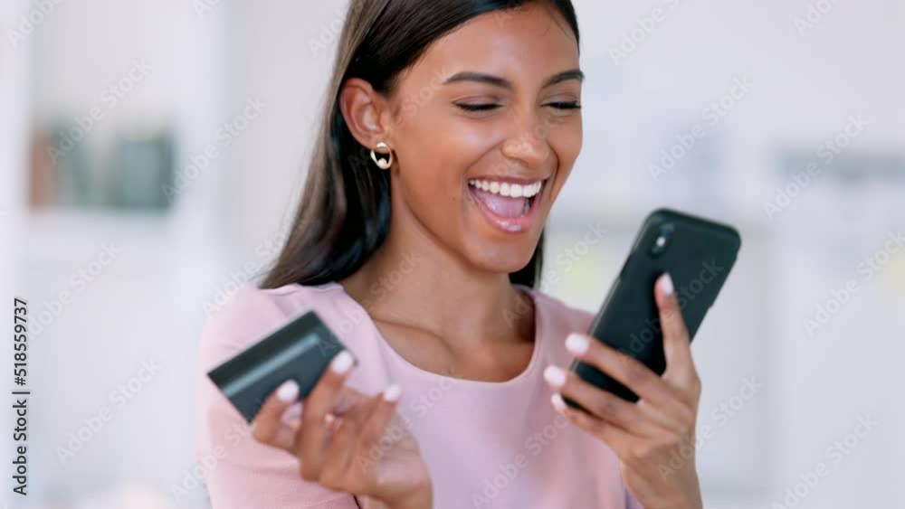 Woman on phone typing credit card details for online shopping, ebanking and ecommerce in home living room. Excited lady winning lottery, buying or ordering final stock item or investing and trading Woman on phone typing credit card details for online shopping, ebanking and ecommerce in home living room. Excited lady winning lottery, buying or ordering final stock item or investing and trading
