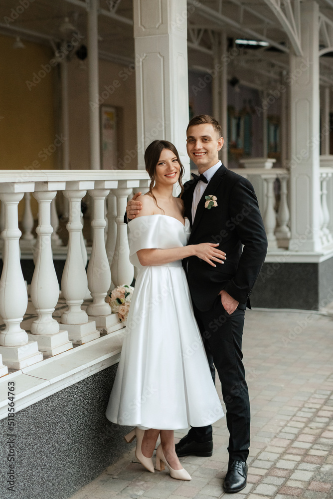 young couple bride and groom in a white short dress