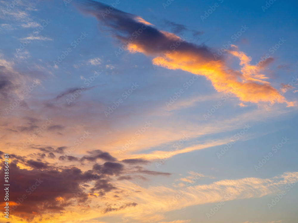 Beautiful sky with clouds at sunrise. Abstract natural cloudy background of the dawn or sunset sky with multicolored clouds