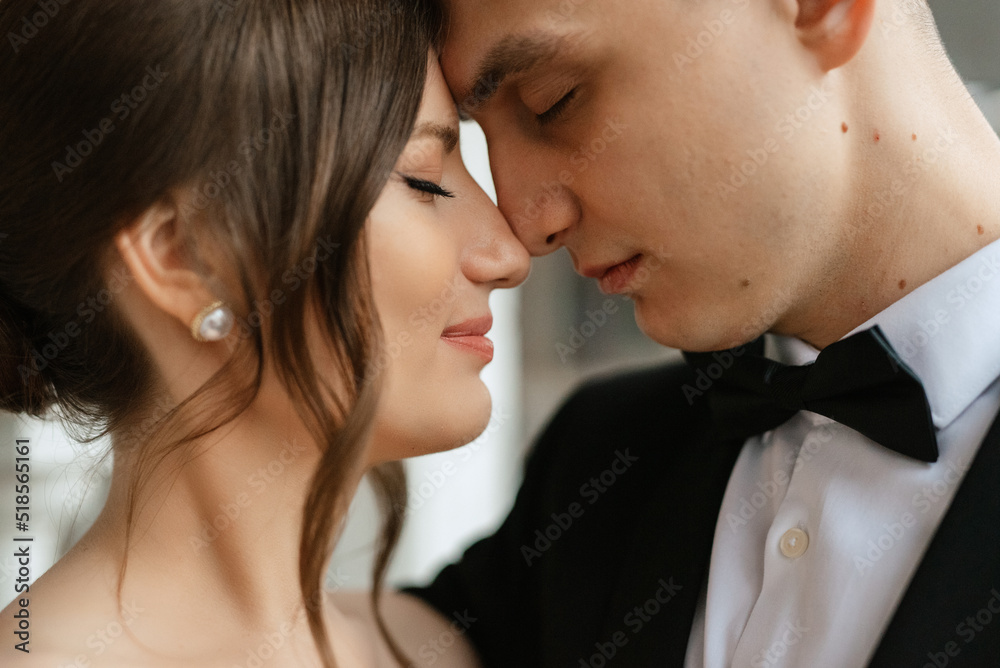 young couple bride and groom in a white short dress young couple bride and groom in a white short dress