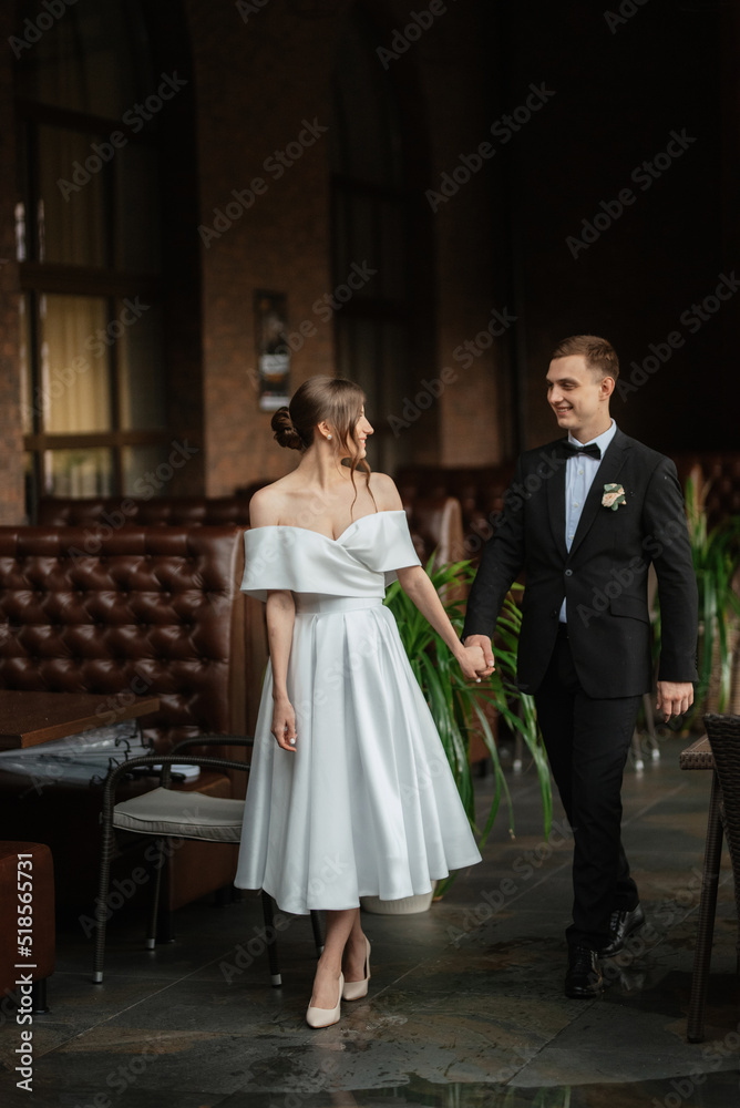 young couple bride and groom in a white short dress