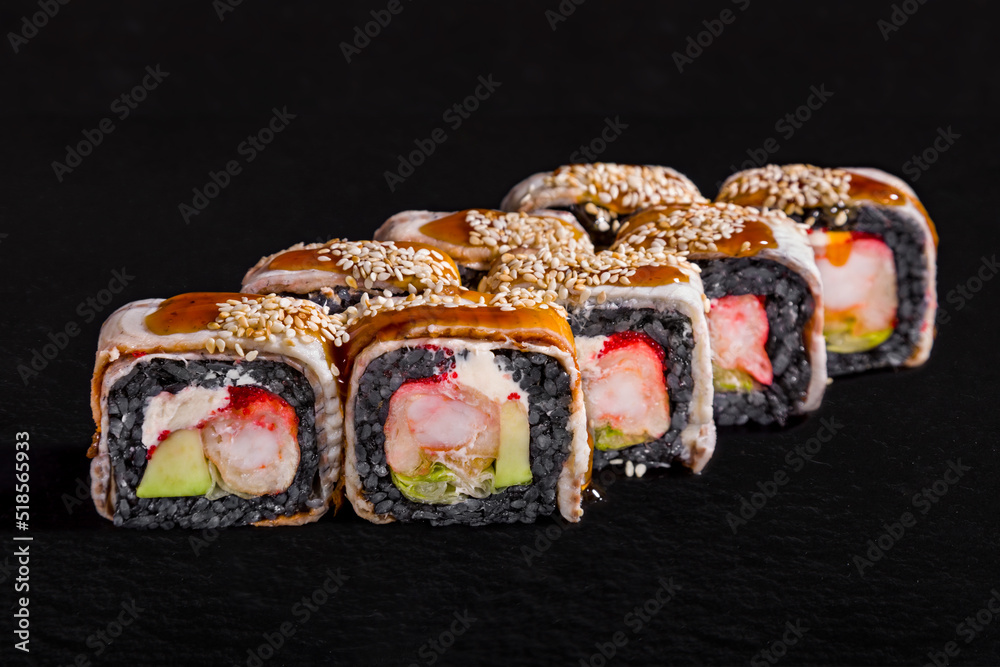 Rolls with black rice, eel, sesame seeds, cream cheese Rolls with black rice, eel, sesame seeds, cream cheese