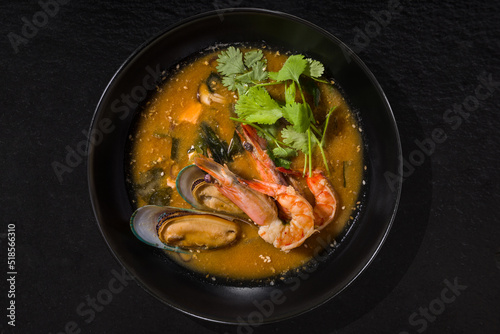 Soup with oysters, shrimps, parsley, sesame seeds and broth