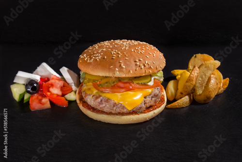 Hamburger with pork cutlet, cheese, tomato, cucumber, sauce