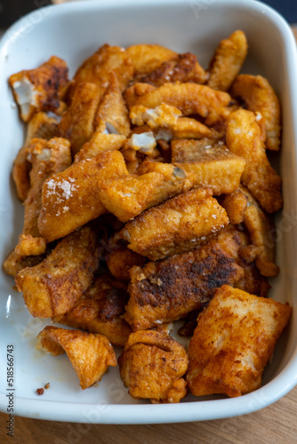 Fried fish in a white tray, crispy golden brown colors 