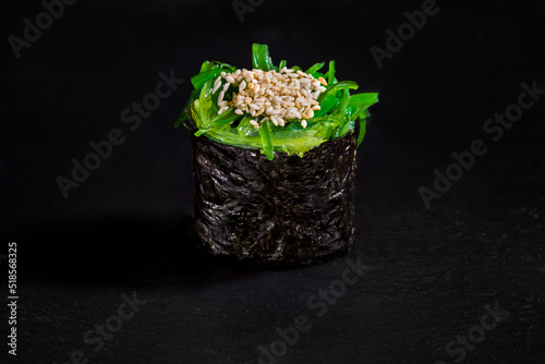 Roll with sesame seeds, chuka and nori photo