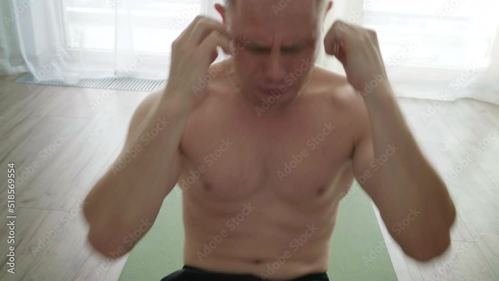 4K Man doing abdomen exercises on yoga mat on floor at home with great effort. Sports, healthcare, working out concept. 4K Man doing abdomen exercises on yoga mat on floor at home with great effort. Sports, healthcare, working out concept.