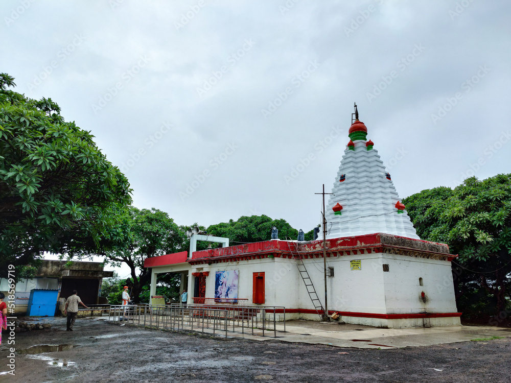 Stock photo of ancient Hindu temple of goddess renukadevi or tembalabai Devi. Temple building painted with white and red color, this temple situated on hill at Kolhapur, Maharashtra, India.