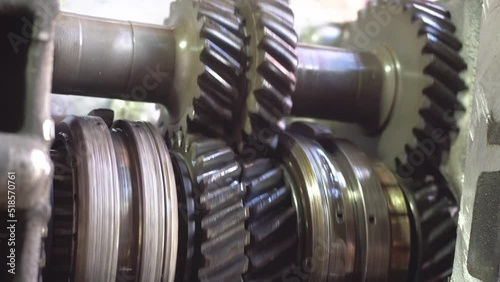 Working gearbox. Gear reducer. Rotating gears. Old gearbox