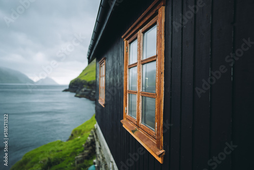 Window on black wall with grass roof. Faroe islands  Europe. Typical house  