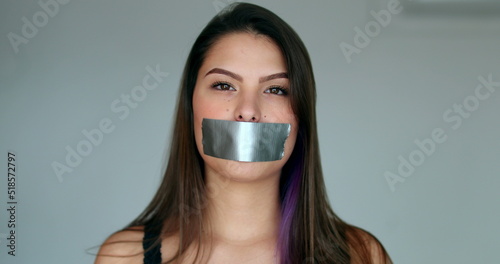 Woman mouth taped looking at camera
