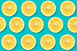 Seamless pattern background Yellow Lemon slices on vibrant blue turquoise color background. Minimal flat lay food texture. 