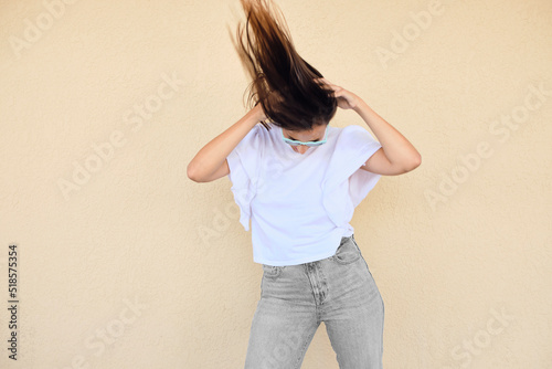 happy young woman posing in a fun way with heart shaped sunglasses 