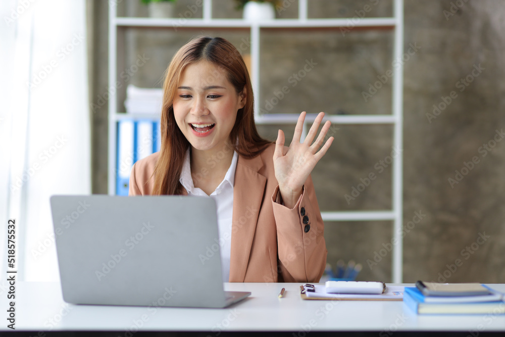 Businesswoman working on laptop and chatting with colleagues via webinar. Businesswoman working on laptop and chatting with colleagues via webinar.