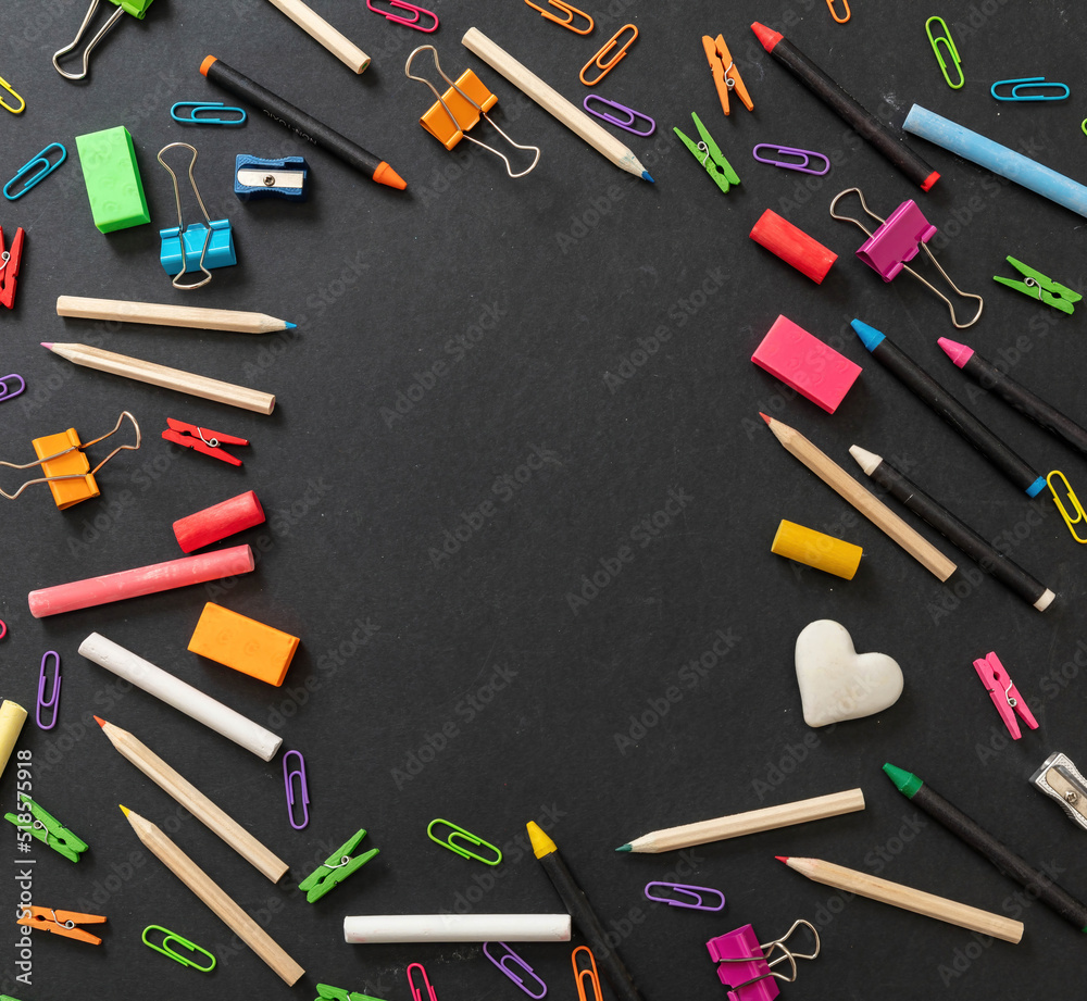 Back to school background. School office supply and stationery flat lay on black, top view Back to school background. School office supply and stationery flat lay on black, top view