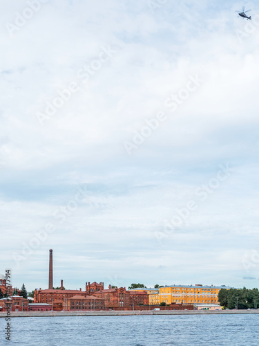 Helicopter flying over the Neva River in St. Petersburg, Russia and Kresty prison, vertical photo