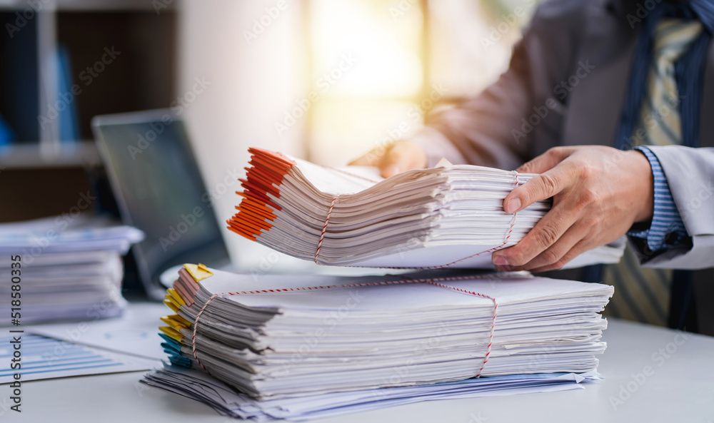 business documents businessman check legal document review Prepare documents or analysis reports, tax items, accounting documents, data contracts, office partner agreements.