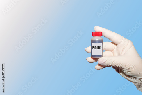 Polio virus. The doctor's hand holds a tissue sample of an infected polio. An outbreak of poliomyelitis.