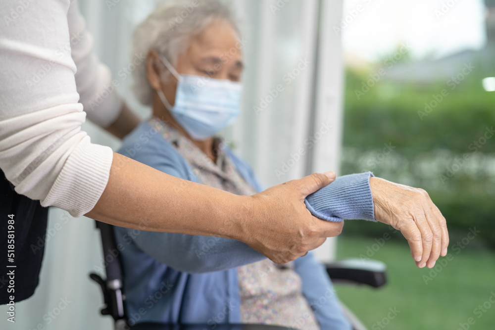 Help Asian senior or elderly old lady woman sitting on wheelchair and wearing a face mask for protect safety infection Covid19 Coronavirus. Help Asian senior or elderly old lady woman sitting on wheelchair and wearing a face mask for protect safety infection Covid19 Coronavirus.