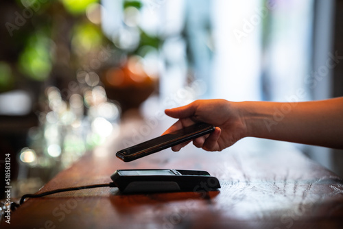 paying with smartphone at a bar