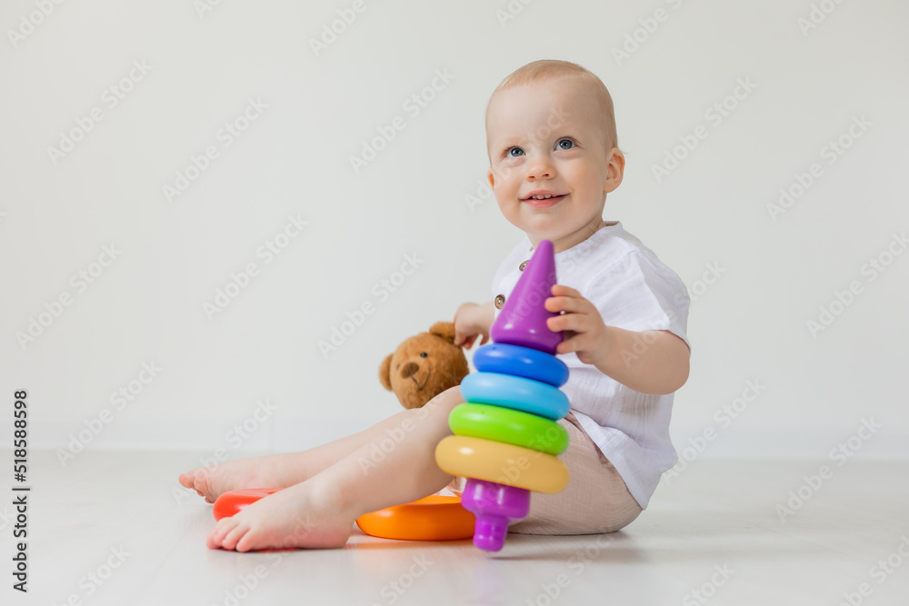 adorable little boy playing with teddy bear on floor, toys, health, banner, card, space for text adorable little boy playing with teddy bear on floor, toys, health, banner, card, space for text