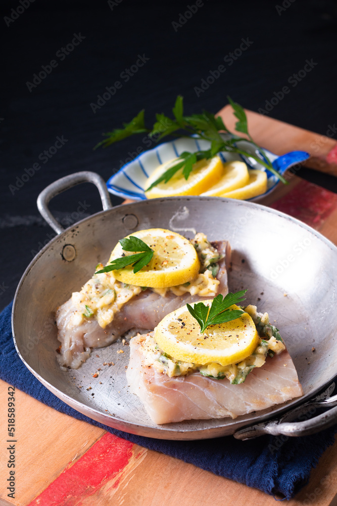 Healthy Food concept preparation for Homemade Lemon garlic butter Baked Cod fish on black background with copy space Healthy Food concept preparation for Homemade Lemon garlic butter Baked Cod fish on black background with copy space