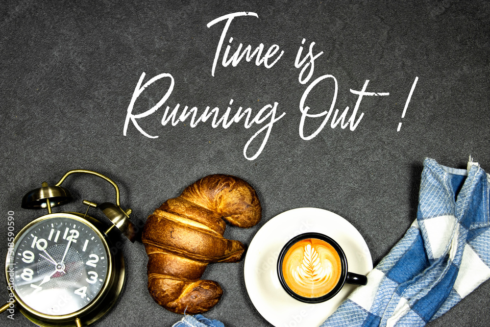 Time is Running Out Concept, Fresh baked croissants on black board for breakfast and coffee cup with leaf late art and alarm clock showing seven o'clock on gray grunge background Time is Running Out Concept, Fresh baked croissants on black board for breakfast and coffee cup with leaf late art and alarm clock showing seven o'clock on gray grunge background