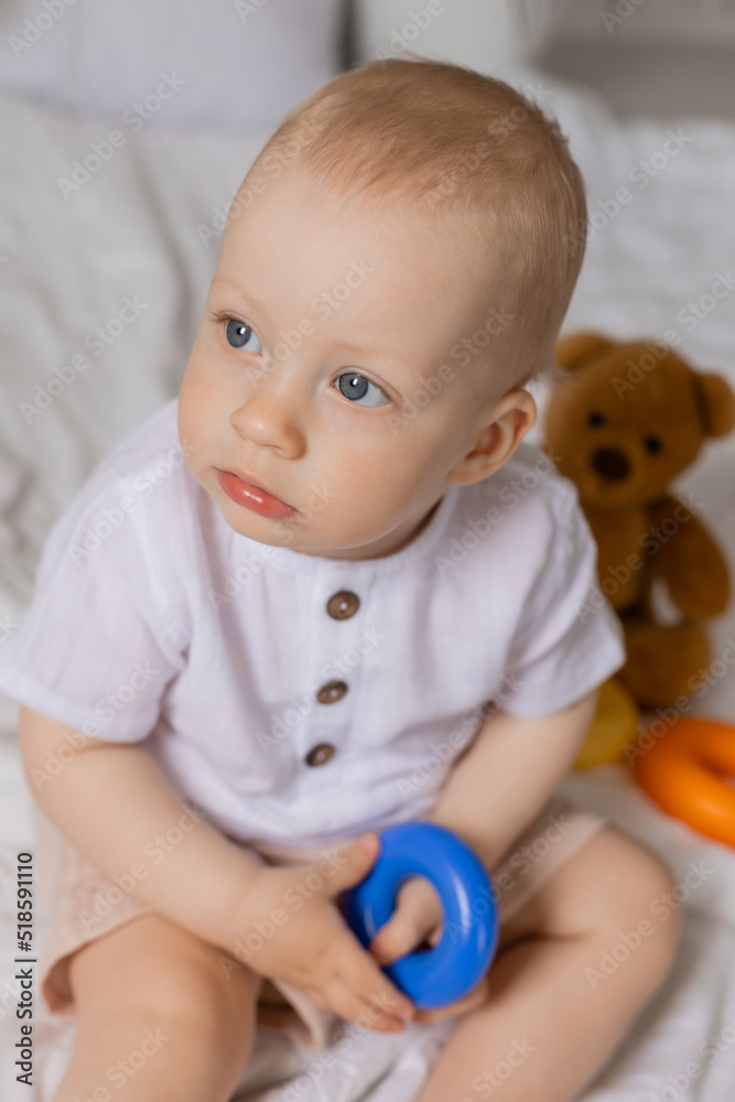 Cheerful little boy playing with toys on blanket, teddy bear, health, banner, card. High quality photo Cheerful little boy playing with toys on blanket, teddy bear, health, banner, card. High quality photo