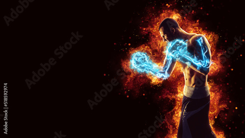 Boxing and fitness concept. Boxer man fighting or posing in gloves on black background with fire. Individual sports recreation. Energy and power