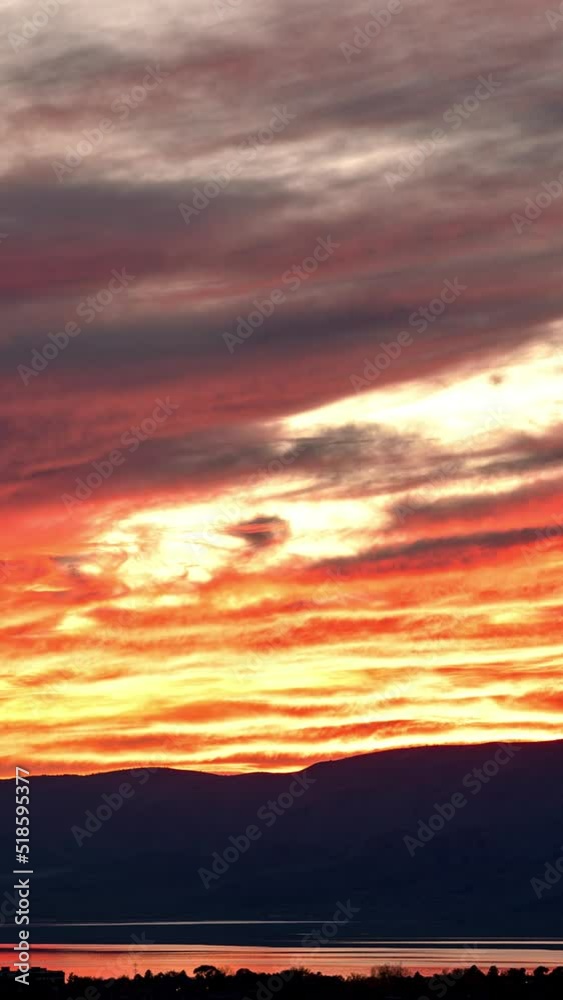 Timelapse of fiery sunset over Utah Lake zoomed across the valley as the wave of color fades. Timelapse of fiery sunset over Utah Lake zoomed across the valley as the wave of color fades.