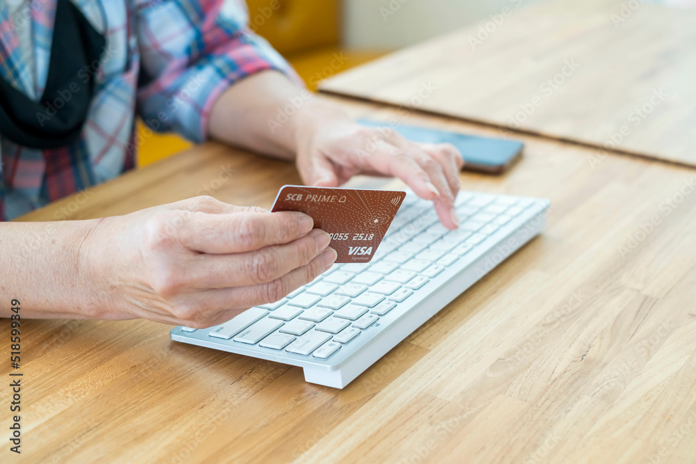 Woman hands holding credit card shopping online. communication online for payment in notebook. female writer keyboard happy cheerful pleased. girl freelance working lifestyle modern at coffee shop. Woman hands holding credit card shopping online. communication online for payment in notebook. female writer keyboard happy cheerful pleased. girl freelance working lifestyle modern at coffee shop.