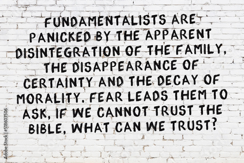 Painted black mindful inscription on white brick wall background photo