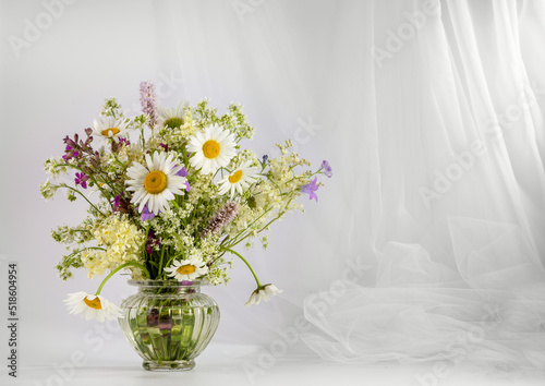 A bouquet of wildflowers on a light background. Copy space for text