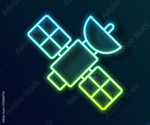 Glowing neon line Satellite icon isolated on black background. Vector