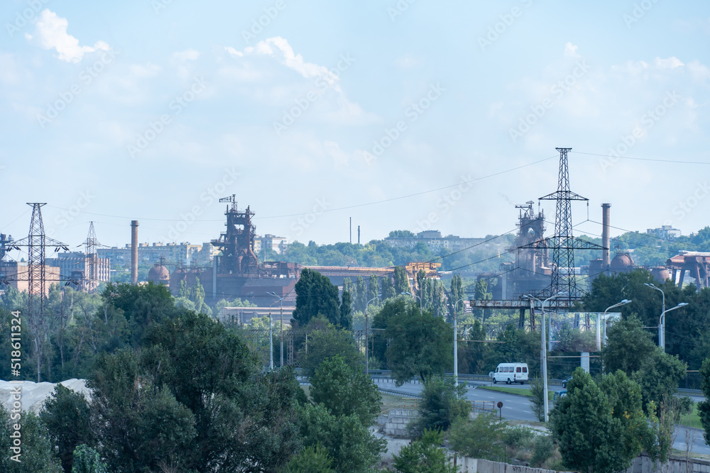 View of industrial plant for the production of metal smelting. Metallurgical plant to the city. Steelmill. Blast furnaces on large integrated steelworks.The problem of ecology in a big city. Smoke.