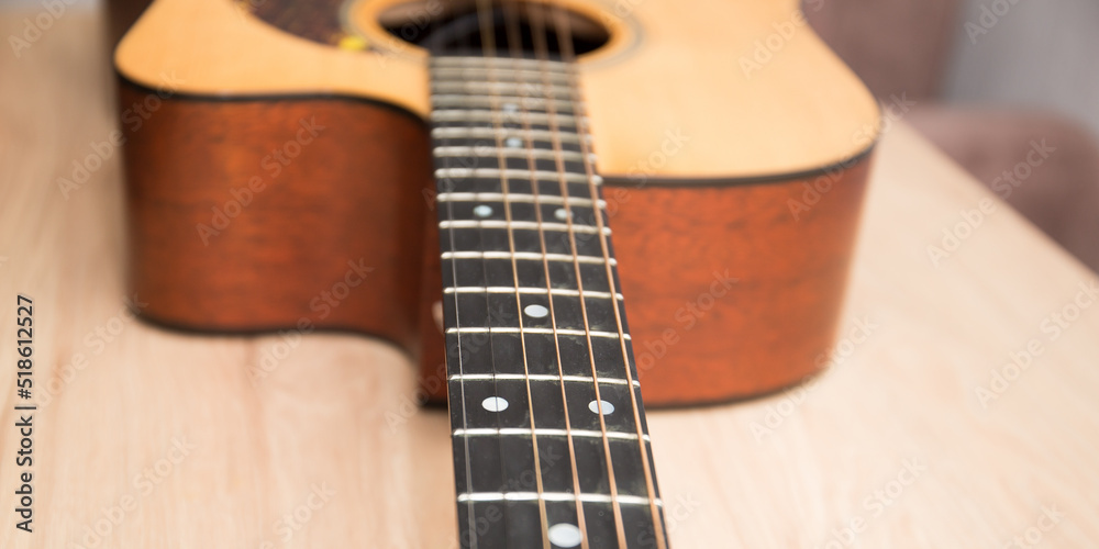 Obraz premium A fragment of the body of an acoustic six-string guitar.