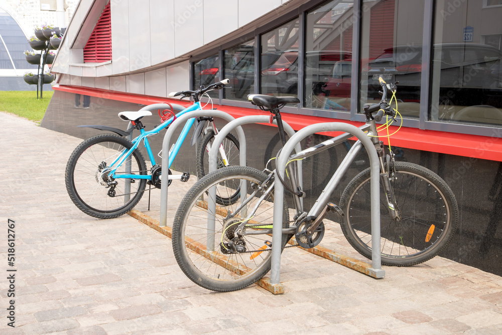 two bikes parked in a street bike rack