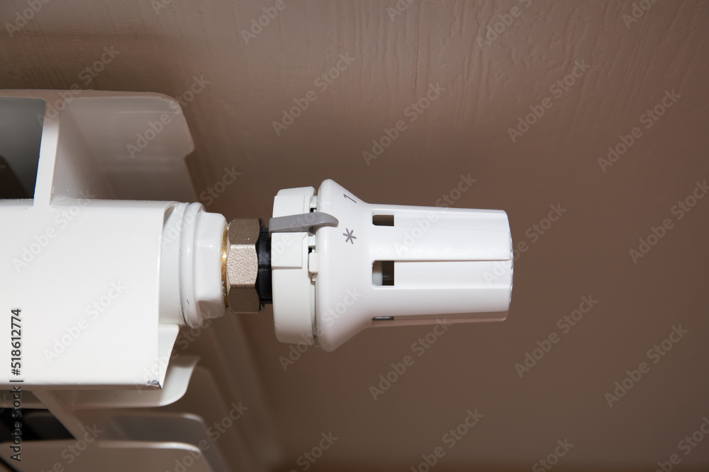 The temperature controller on the radiator is white. The temperature controller on the radiator is white.