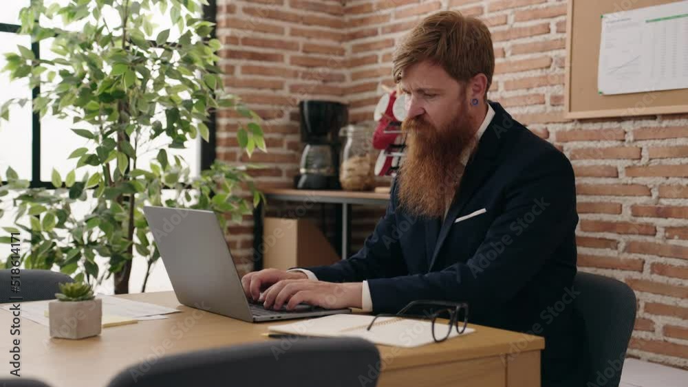 Young redhead man business worker using laptop working at office